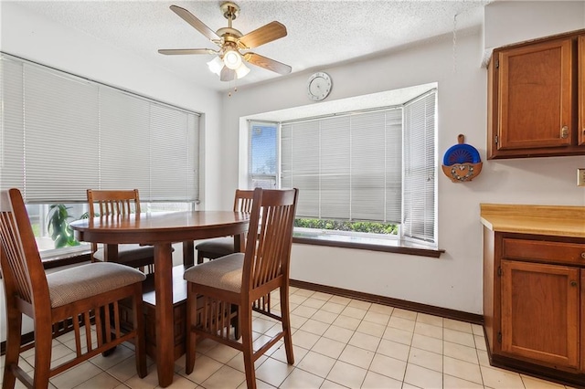 20 Cocodrie Ct, Kenner, LA 70065 - dining space featuring baseboards, a ceiling fan, a textured ceiling, and light tile patterned floors