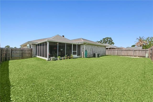 20 Cocodrie Ct, Kenner, LA 70065 - back of property featuring a lawn, brick siding, a fenced backyard, and a sunroom