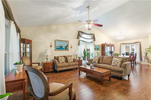 living room with a textured ceiling, ceiling fan with notable chandelier, and dark wood-type flooring