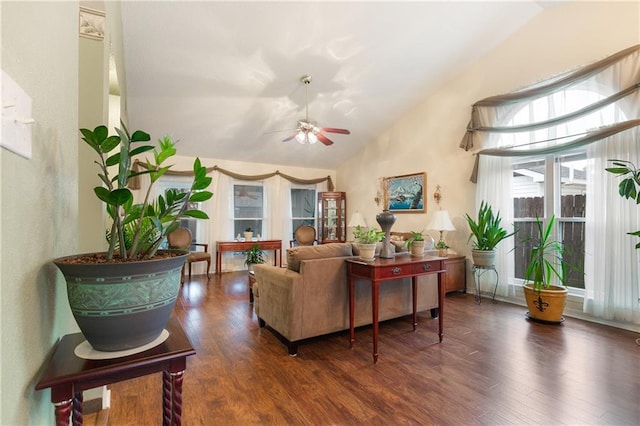 living room with ceiling fan, dark hardwood / wood-style flooring, and high vaulted ceiling