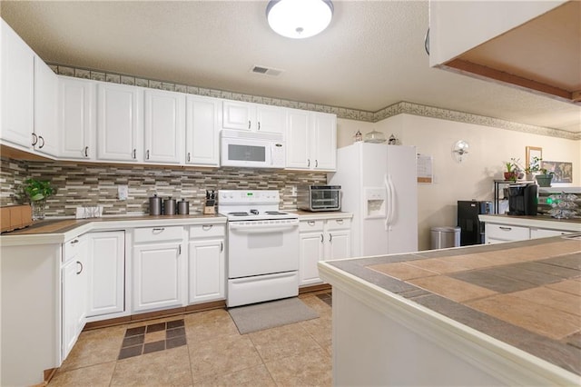 kitchen with white cabinets, white appliances, and tasteful backsplash