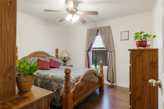 bedroom with ceiling fan and dark wood-type flooring