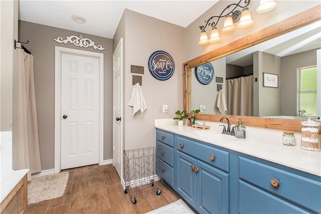 bathroom with hardwood / wood-style floors and vanity