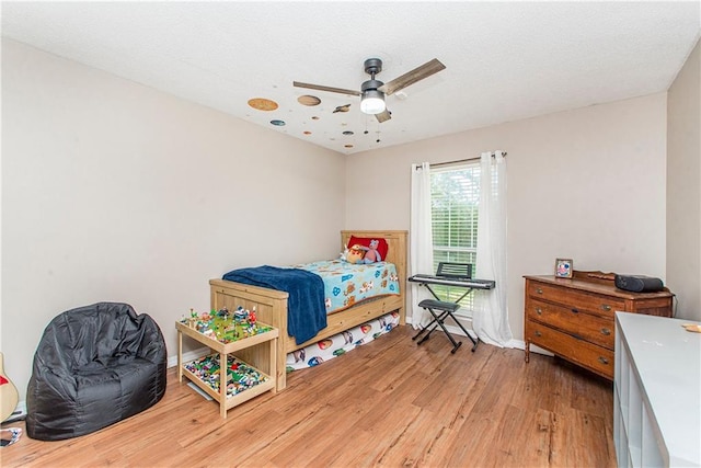 bedroom with hardwood / wood-style flooring and ceiling fan