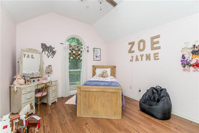 bedroom featuring ceiling fan, light hardwood / wood-style floors, and vaulted ceiling