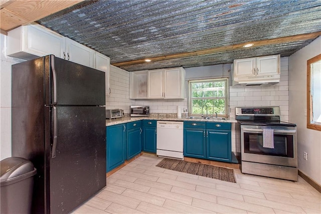 kitchen featuring light wood-type flooring, stainless steel appliances, sink, blue cabinetry, and white cabinets