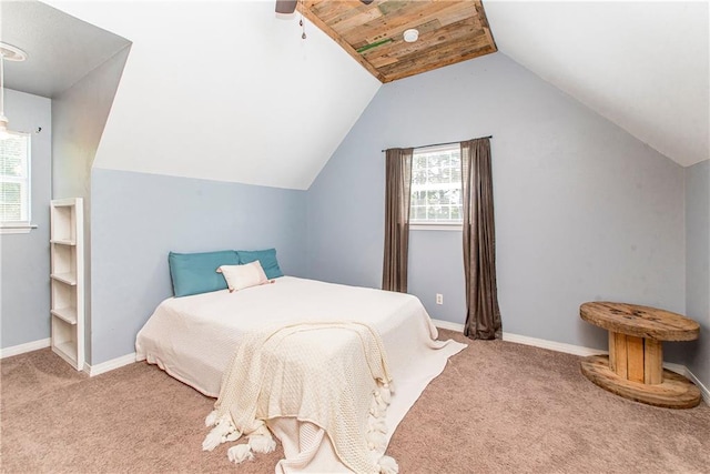 carpeted bedroom featuring multiple windows, ceiling fan, wooden ceiling, and vaulted ceiling