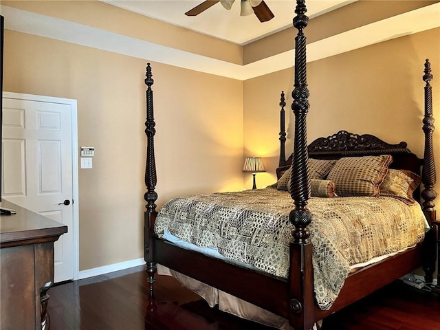 bedroom with ceiling fan and dark wood-type flooring