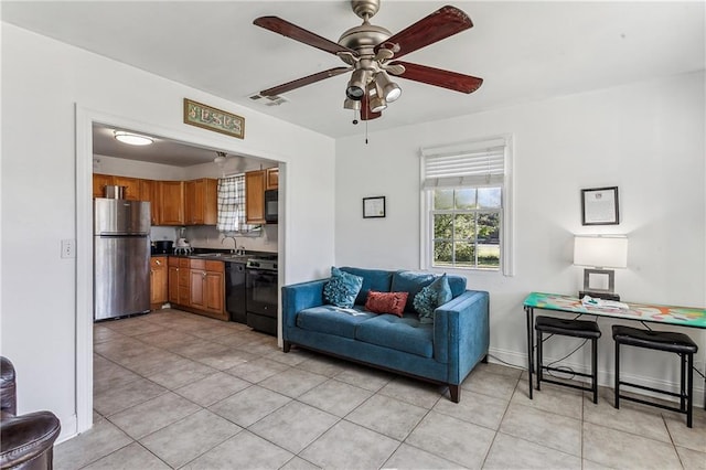 tiled living room featuring ceiling fan and sink