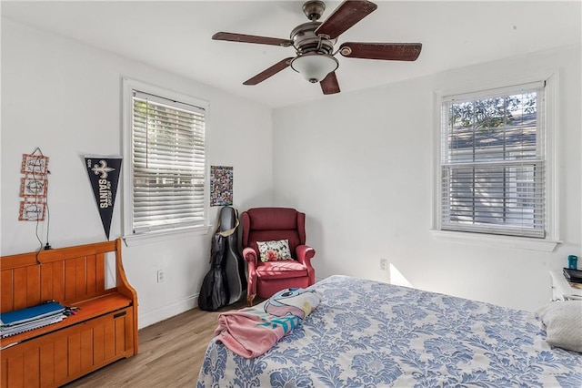 bedroom with multiple windows, ceiling fan, and light wood-type flooring