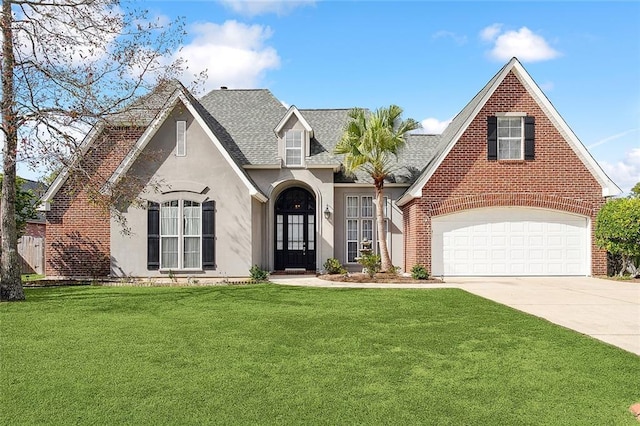 view of front facade with french doors, a garage, and a front lawn