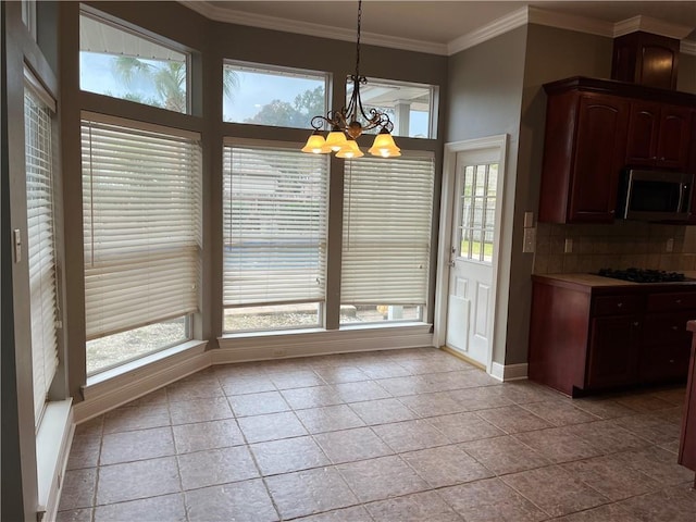 unfurnished dining area featuring light tile patterned floors, ornamental molding, and a notable chandelier