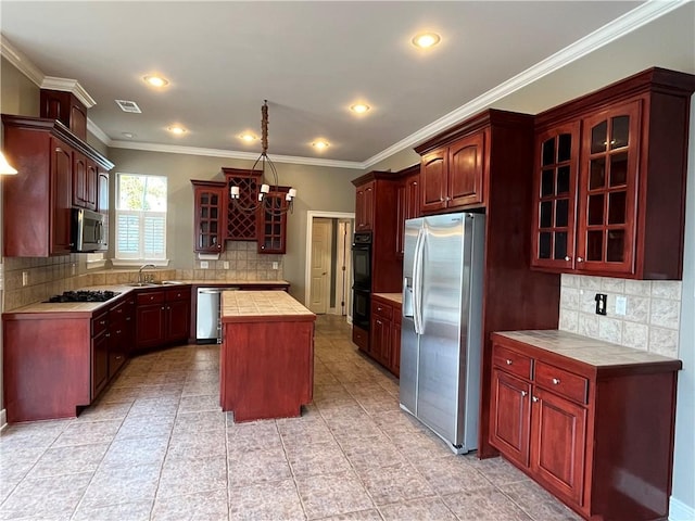 kitchen featuring black appliances, a center island, and tasteful backsplash