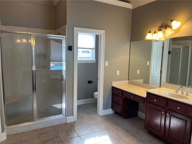 bathroom with an enclosed shower, vanity, toilet, and ornamental molding