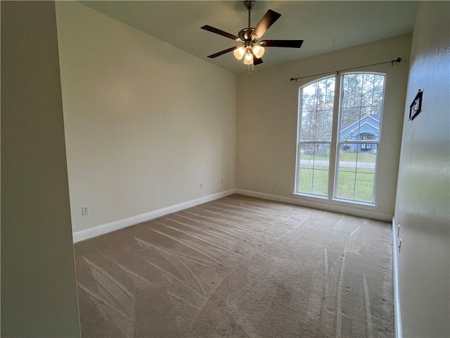 unfurnished room with light carpet and ceiling fan