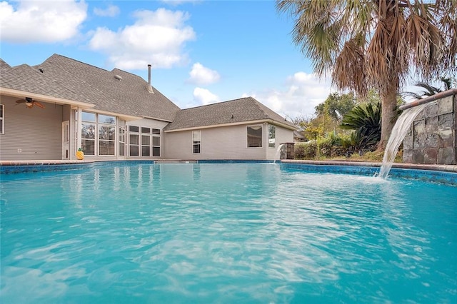 view of swimming pool with pool water feature