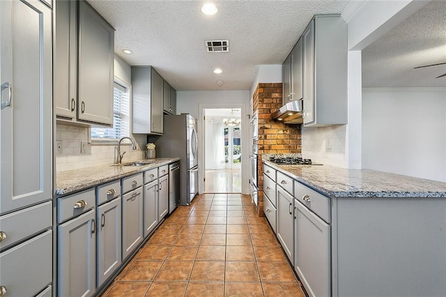 kitchen with sink, a wealth of natural light, and tasteful backsplash