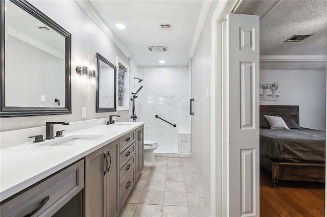 bathroom with tile patterned floors, vanity, crown molding, tiled shower, and toilet