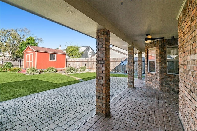 view of patio / terrace with a shed and ceiling fan