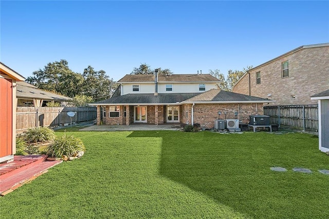 rear view of property with a patio, central AC unit, and a lawn