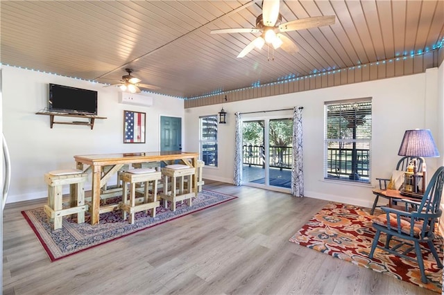 dining area with a wall mounted AC, hardwood / wood-style floors, ceiling fan, and wooden ceiling