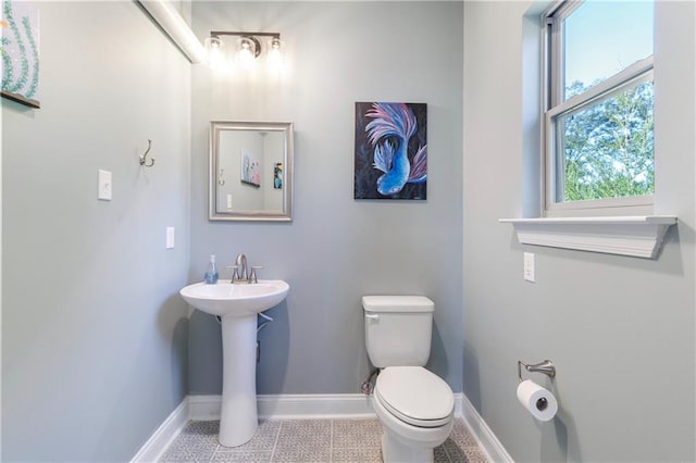 bathroom featuring tile patterned floors, toilet, and sink