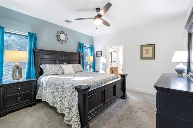 bedroom featuring ensuite bathroom, ceiling fan, and light carpet