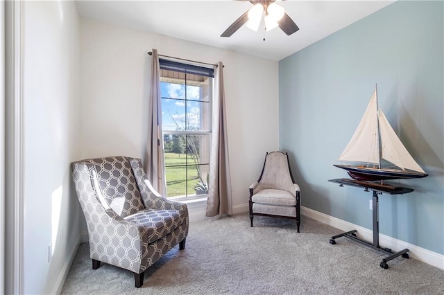 sitting room featuring carpet and ceiling fan