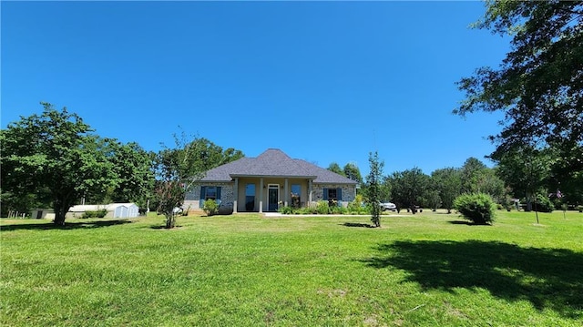 exterior space featuring covered porch and a front yard