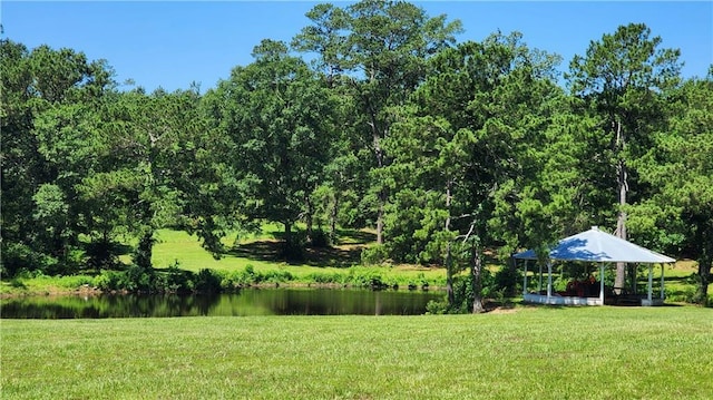 view of yard featuring a gazebo and a water view