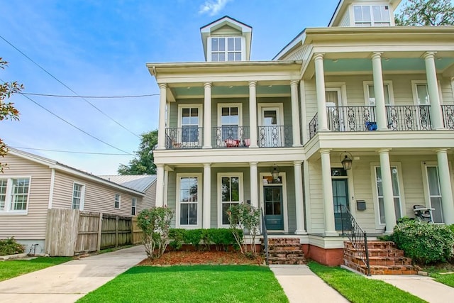 view of front of home with a balcony and covered porch