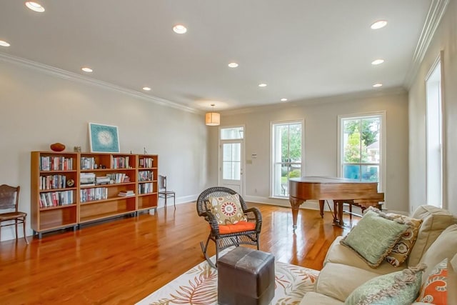 living room featuring crown molding and light wood-type flooring