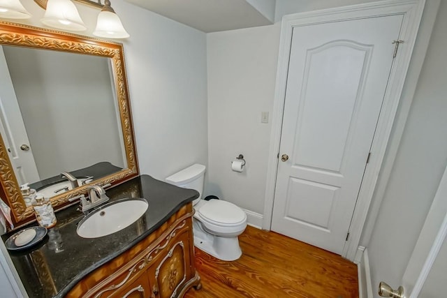 bathroom featuring vanity, hardwood / wood-style flooring, and toilet