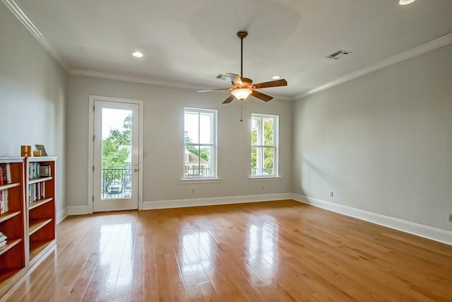 spare room featuring crown molding, ceiling fan, and light wood-type flooring