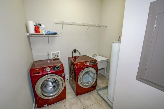 washroom with light tile patterned floors, sink, electric panel, independent washer and dryer, and gas water heater