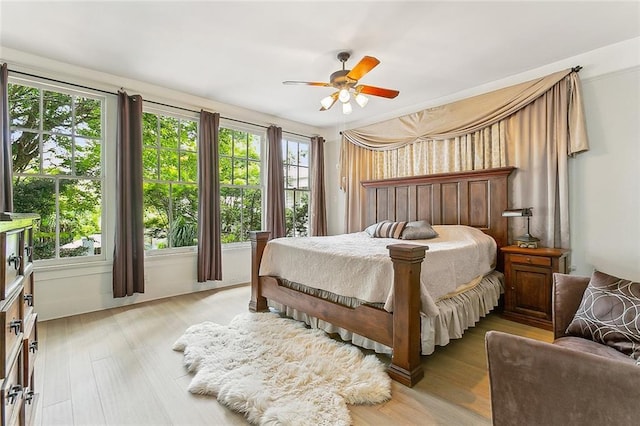 bedroom with ceiling fan and light hardwood / wood-style flooring