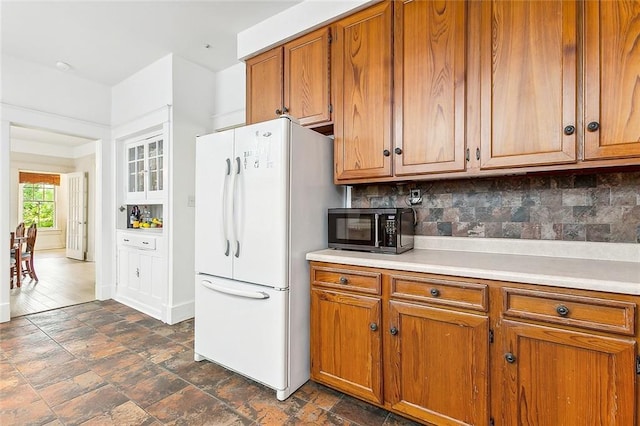 kitchen featuring tasteful backsplash and white fridge