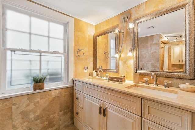 bathroom with crown molding, vanity, and tile walls