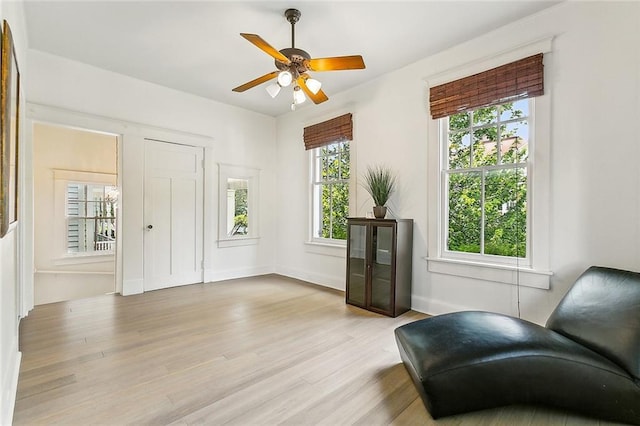 sitting room featuring ceiling fan and light hardwood / wood-style flooring