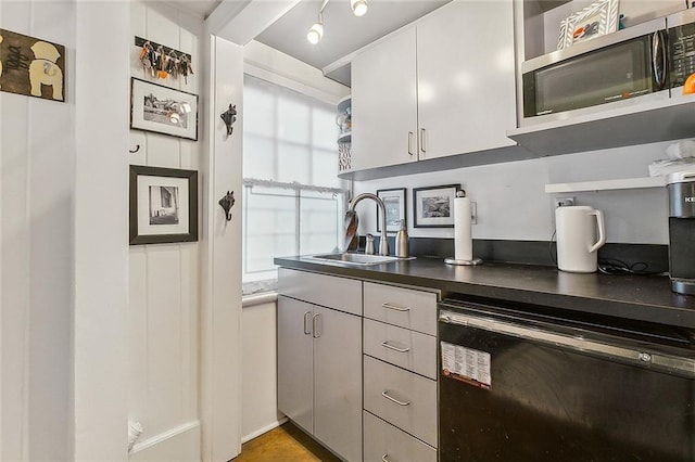 kitchen featuring white cabinetry, sink, and dishwasher