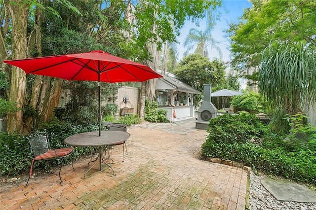 view of patio featuring exterior fireplace