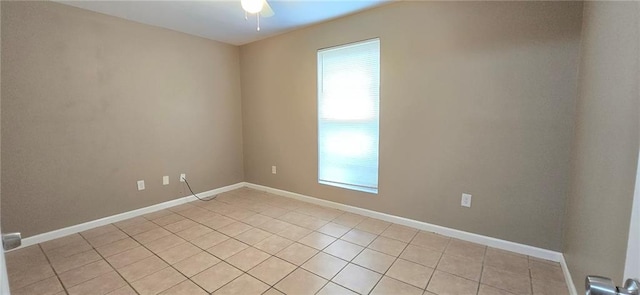 empty room featuring light tile patterned floors and ceiling fan