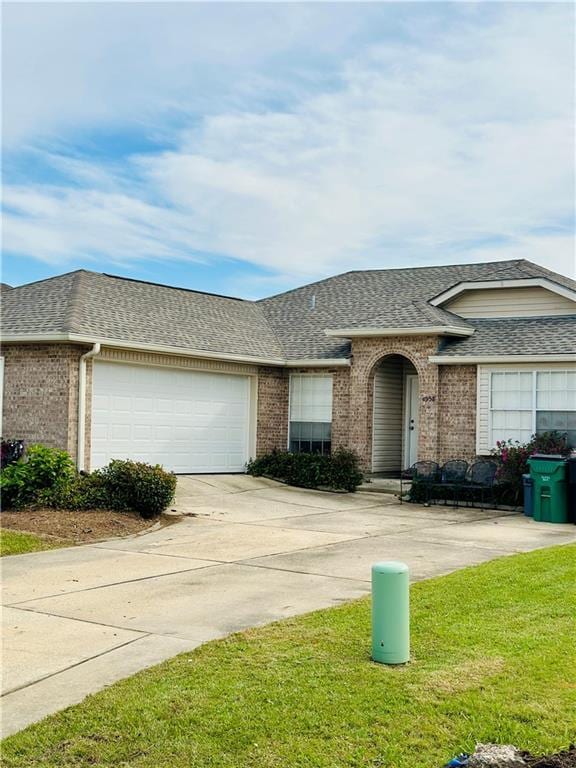 single story home with a front lawn and a garage