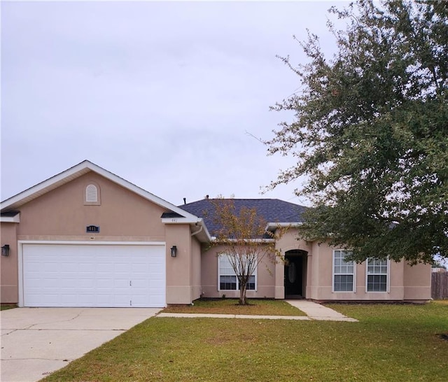 single story home with a garage and a front lawn