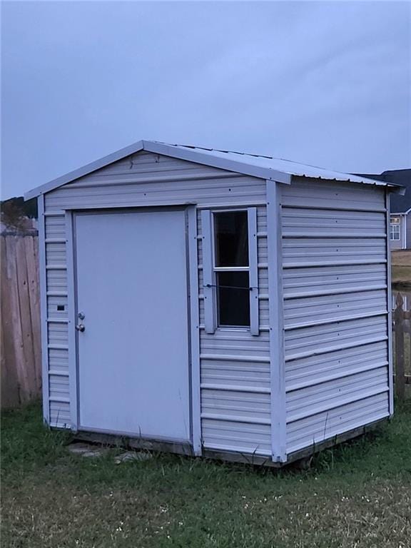view of shed featuring fence