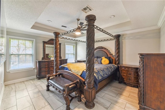 bedroom with a raised ceiling, ceiling fan, crown molding, and a textured ceiling