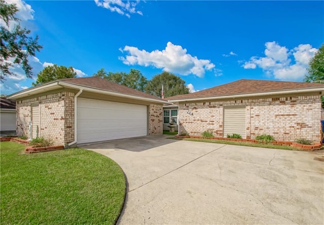 single story home featuring a garage and a front lawn