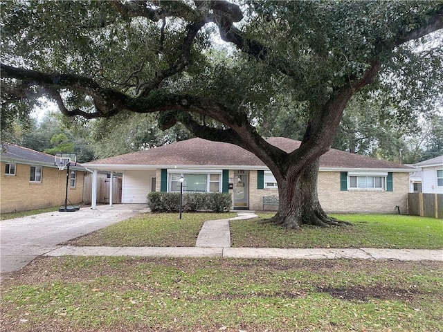 single story home featuring a front lawn and a carport