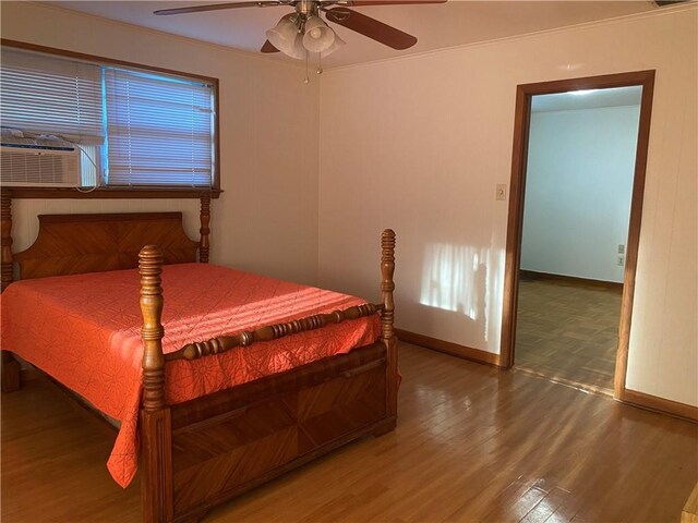 bedroom with ceiling fan, cooling unit, and wood-type flooring