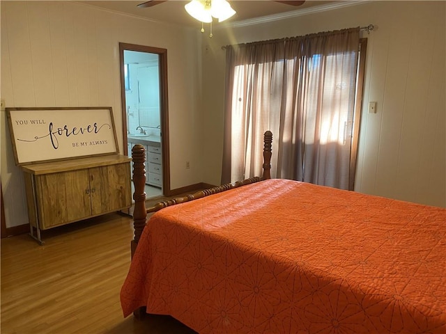 bedroom with wood-type flooring, connected bathroom, ornamental molding, and ceiling fan